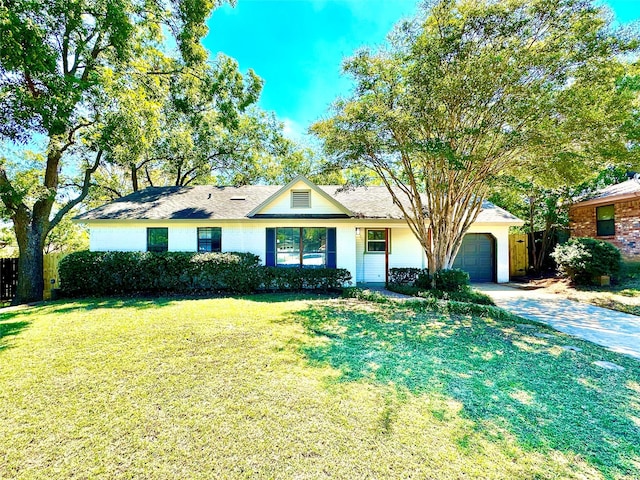 ranch-style house with a garage and a front lawn