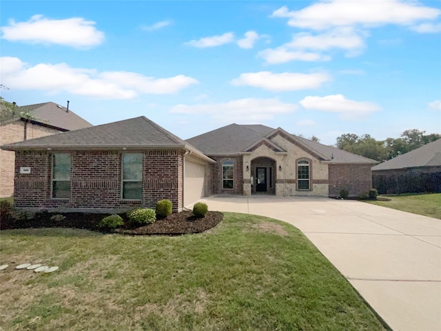 ranch-style home with a front lawn and a garage