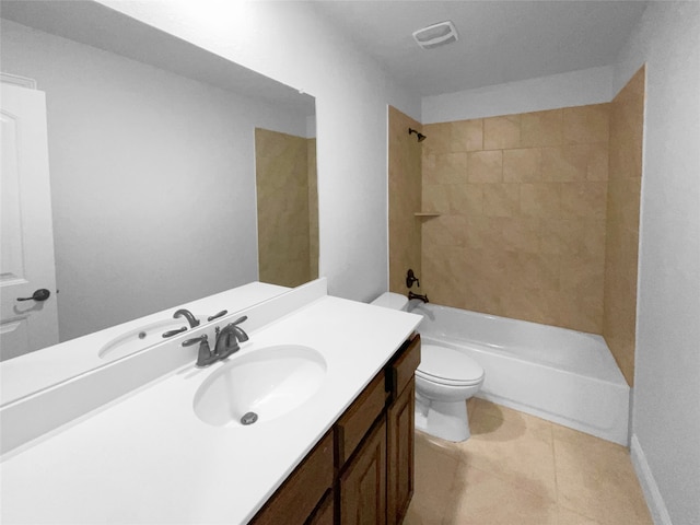 full bathroom featuring tiled shower / bath, vanity, toilet, and tile patterned floors