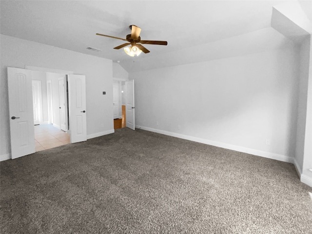 unfurnished bedroom with vaulted ceiling, light carpet, and ceiling fan