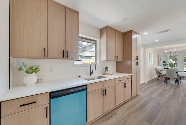 kitchen with dishwashing machine, visible vents, a sink, and light brown cabinetry