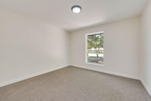 carpeted spare room with baseboards