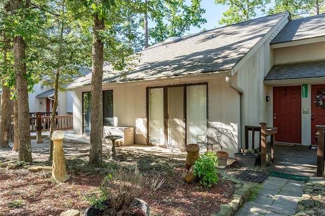 back of house featuring a wooden deck