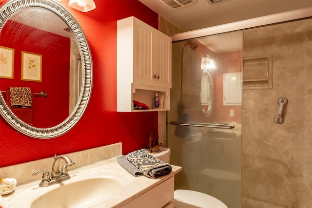 bathroom featuring walk in shower, vanity, and toilet