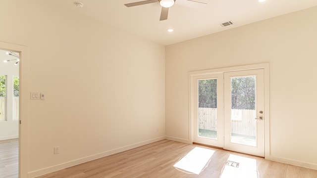 spare room with ceiling fan, light wood-type flooring, and a wealth of natural light