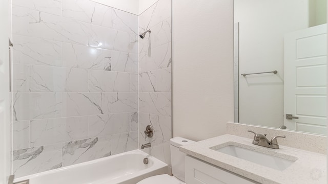 full bathroom with tiled shower / bath combo, vanity, and toilet