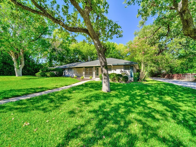 ranch-style home with a front yard