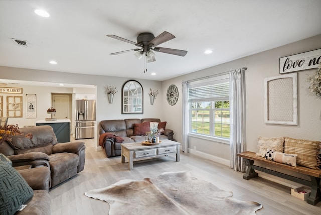 living room with light wood-type flooring and ceiling fan