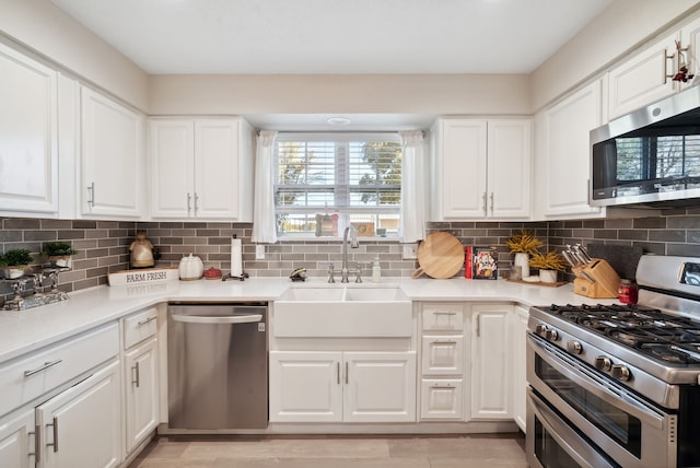 kitchen featuring stainless steel appliances and white cabinetry