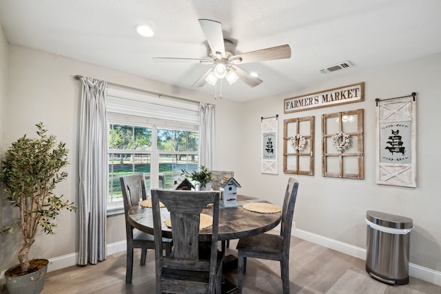 dining space featuring wood-type flooring and ceiling fan