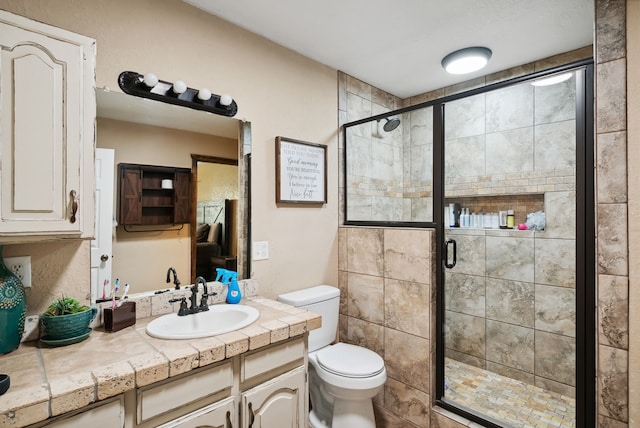 bathroom with walk in shower, vanity, and toilet