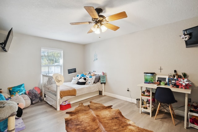 bedroom featuring ceiling fan and light hardwood / wood-style floors