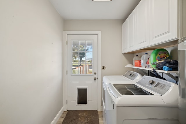 washroom featuring washer and clothes dryer, cabinets, and hardwood / wood-style flooring