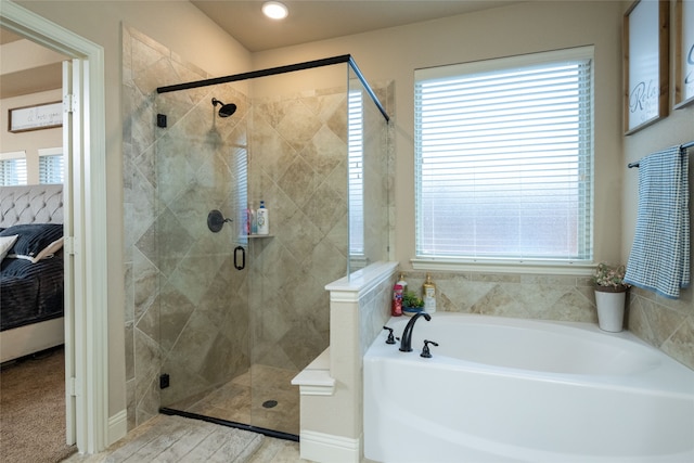 bathroom with separate shower and tub