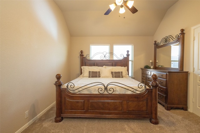 bedroom featuring ceiling fan, vaulted ceiling, and light carpet