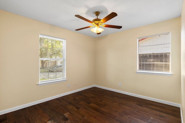 unfurnished room featuring a textured ceiling, dark hardwood / wood-style flooring, and ceiling fan