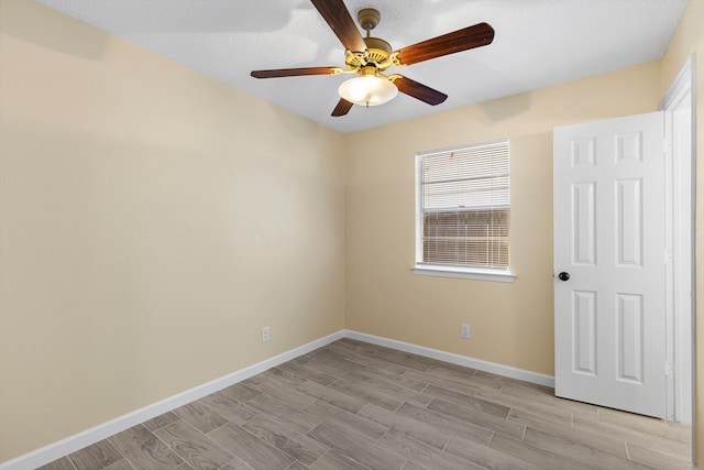 interior space with ceiling fan, a textured ceiling, and light wood-type flooring