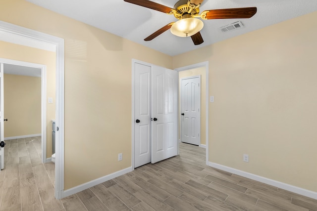 unfurnished bedroom with ceiling fan and light hardwood / wood-style flooring