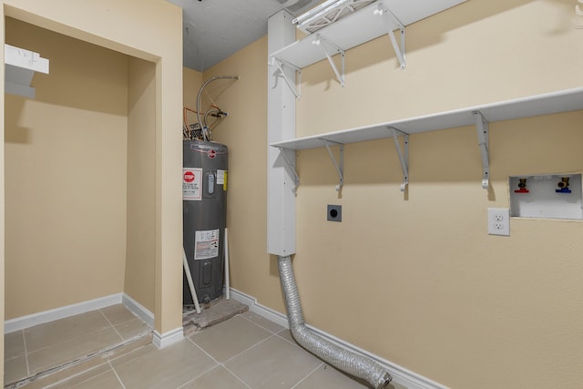 laundry room featuring tile patterned flooring, electric dryer hookup, and electric water heater