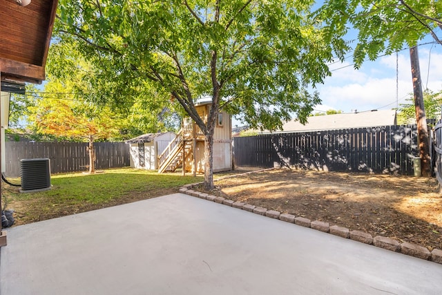 view of patio featuring central AC and an outbuilding