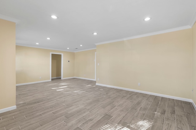 spare room with crown molding and light hardwood / wood-style floors