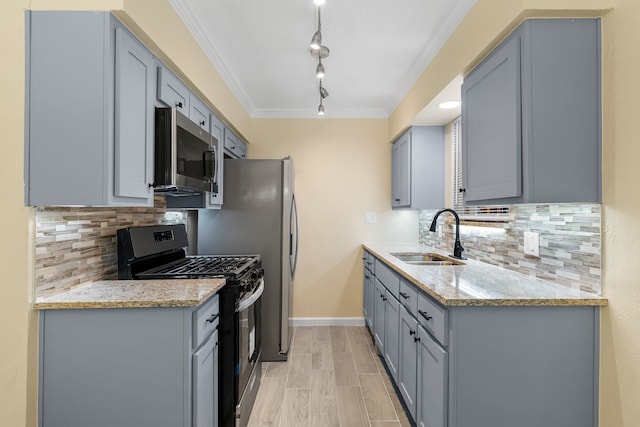 kitchen featuring gray cabinets, light stone countertops, sink, and stainless steel appliances