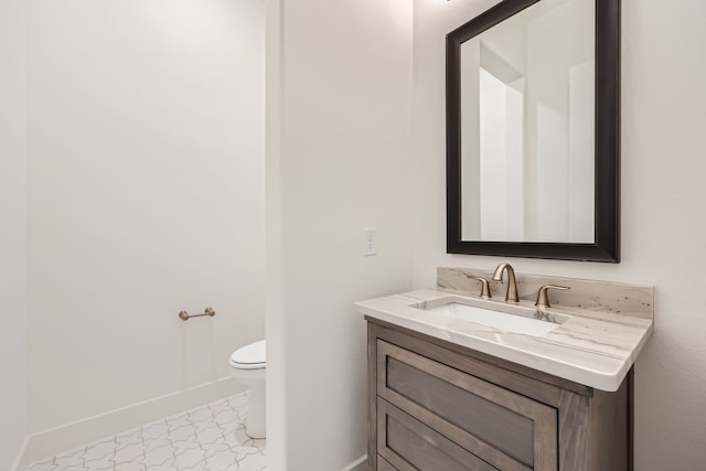 bathroom featuring toilet and vanity