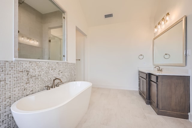 bathroom featuring vanity, tasteful backsplash, shower with separate bathtub, and tile patterned flooring