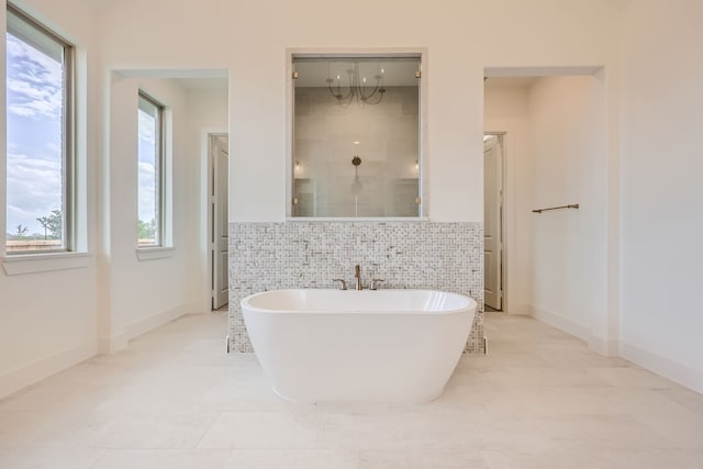 bathroom featuring shower with separate bathtub, tile walls, and tile patterned flooring