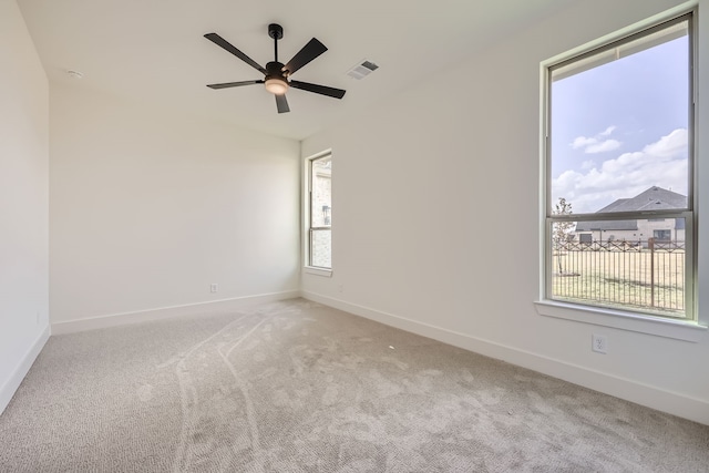 empty room featuring light colored carpet and ceiling fan