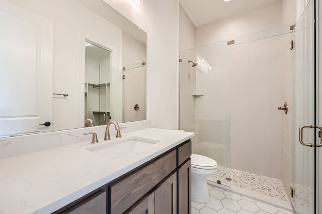 bathroom with toilet, walk in shower, vanity, and tile patterned flooring