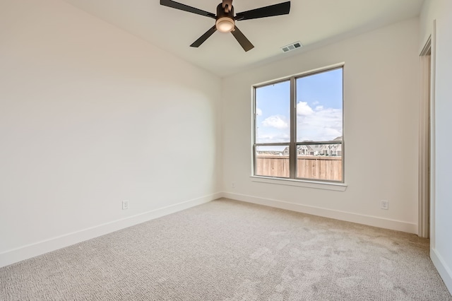 unfurnished room featuring light carpet and ceiling fan