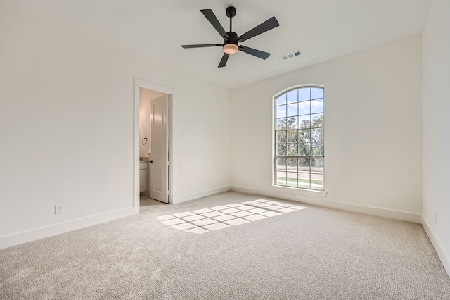 carpeted spare room with ceiling fan