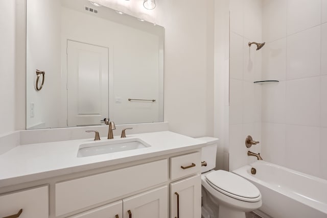 full bathroom with vanity, toilet, and tiled shower / bath combo