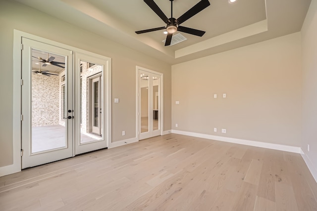 spare room with light hardwood / wood-style floors, french doors, and ceiling fan