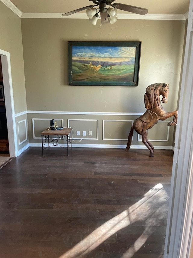 living area featuring dark wood-type flooring, ceiling fan, and crown molding