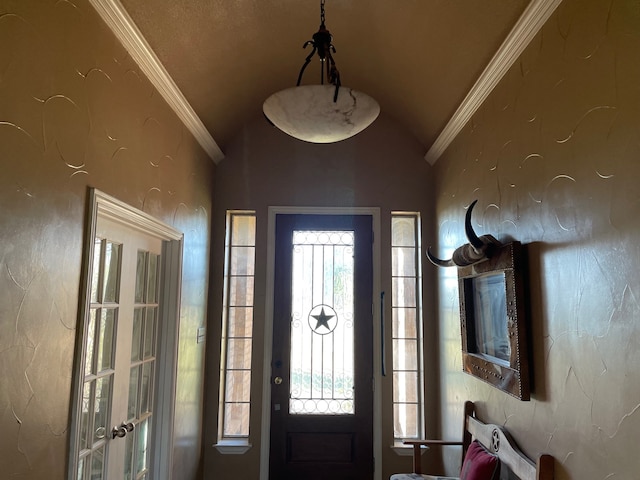 foyer entrance featuring vaulted ceiling and ornamental molding