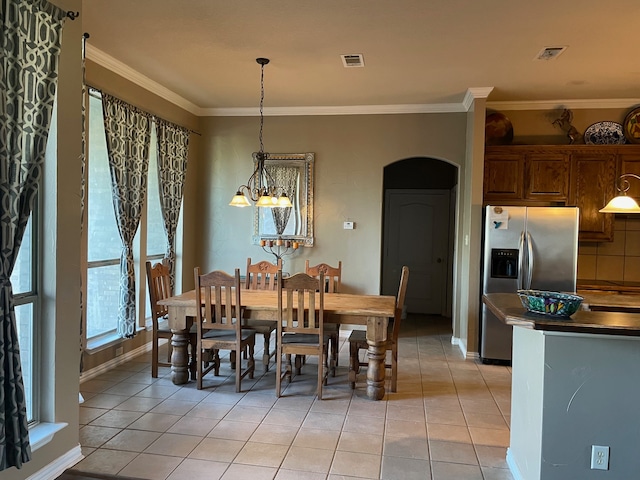 dining area with a notable chandelier, light tile patterned flooring, and ornamental molding