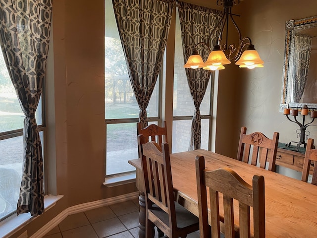 tiled dining room with a notable chandelier