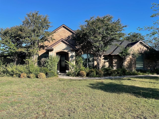 obstructed view of property with a front yard