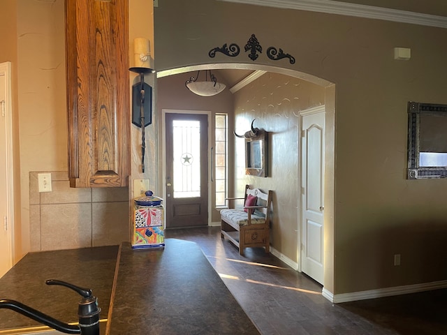 entryway featuring crown molding