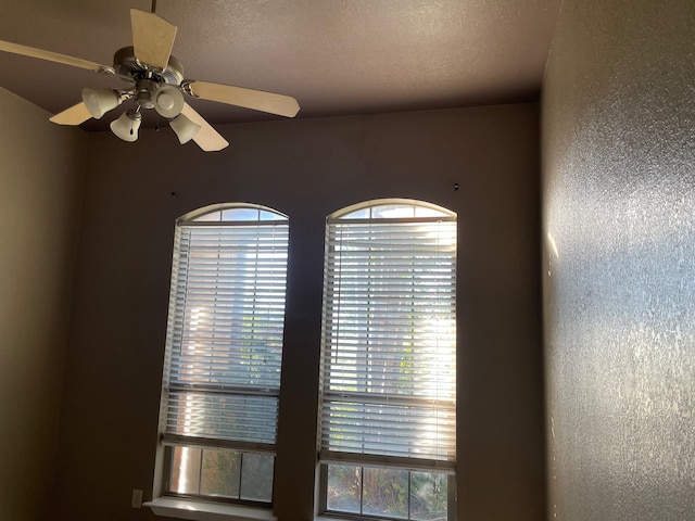 room details featuring a textured ceiling and ceiling fan