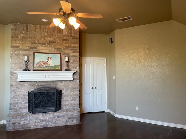 unfurnished living room with a fireplace, vaulted ceiling, ceiling fan, and dark wood-type flooring