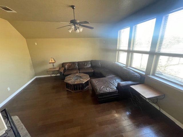 unfurnished living room with dark hardwood / wood-style floors, ceiling fan, and vaulted ceiling