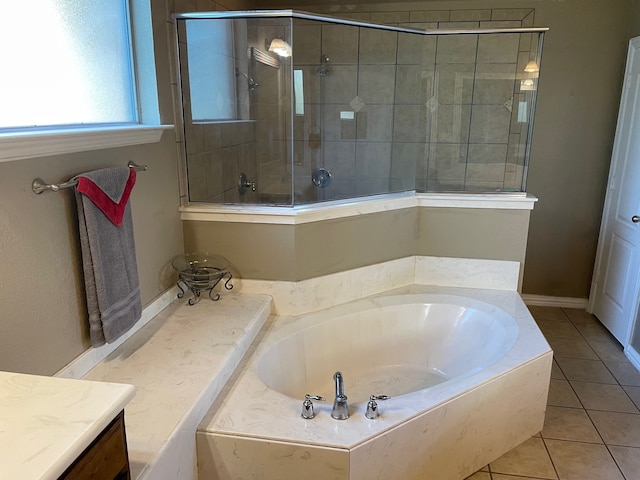 bathroom with tile patterned floors, plus walk in shower, and vanity