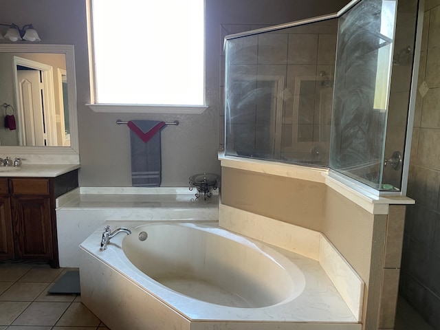 bathroom featuring tile patterned flooring, shower with separate bathtub, and vanity