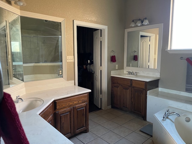 bathroom featuring tile patterned flooring, vanity, and a washtub