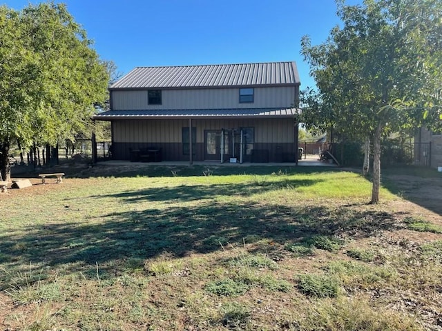 back of property featuring a lawn