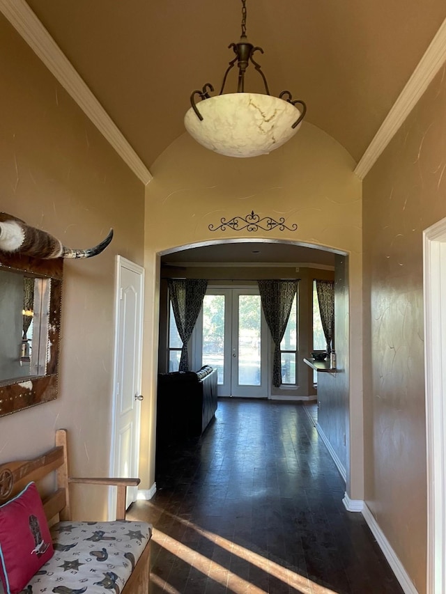 corridor featuring dark hardwood / wood-style flooring, ornamental molding, high vaulted ceiling, and french doors