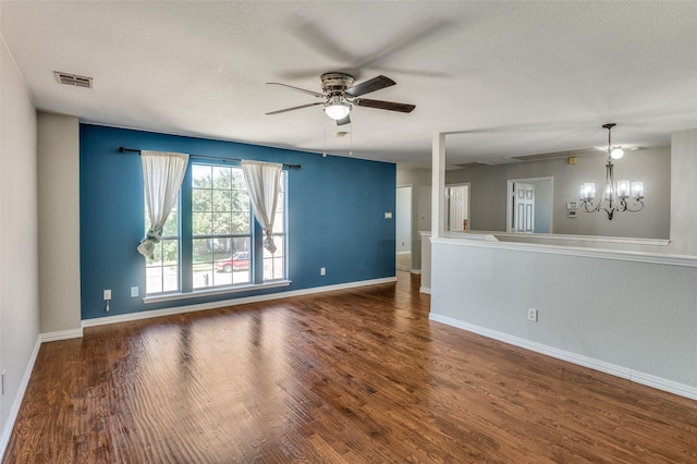 unfurnished room featuring ceiling fan with notable chandelier and dark hardwood / wood-style floors